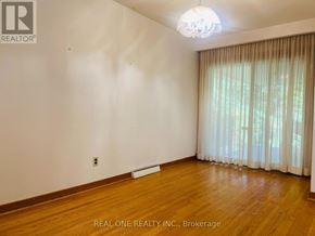 Toronto (Willowdale East) apartment for rent - A room with wooden floors and a window with curtains.