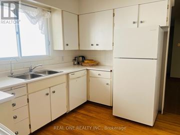 Toronto (Willowdale East) apartment for rent - A white kitchen with wooden floors and a sink.