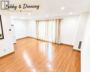 Toronto (Pleasant View) townhouse for rent - A spacious dining room with wooden flooring and white walls.