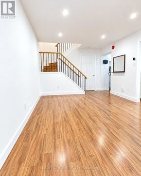 Toronto (Pleasant View) townhouse for rent - A hallway with wooden floors and a staircase.