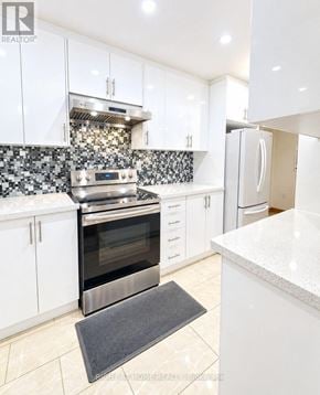 Toronto (Pleasant View) townhouse for rent - A modern kitchen with white cabinets and a tiled backsplash.