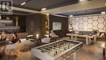 Toronto (Flemingdon Park) condo for rent - A modern living room with a foosball table in the center.