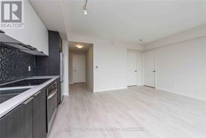 Toronto (Flemingdon Park) condo for rent - A spacious kitchen with dark cabinets and a white countertop.