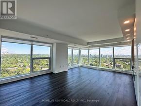 Toronto (North St. James Town) condo for rent - A large, empty room with a view of the cityscape outside the windows.