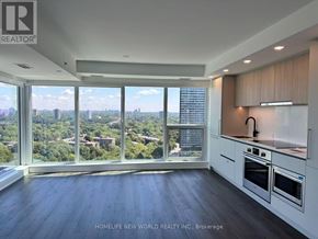 Toronto (North St. James Town) condo for rent - A spacious kitchen with a view of the cityscape.