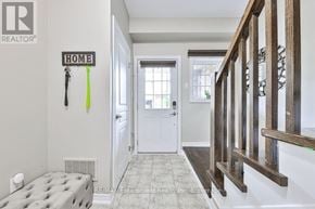 Grimsby (Grimsby Beach) townhouse for rent - A hallway with a white door and a sign that says "HOME".