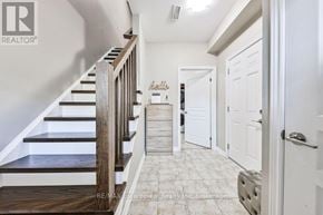 Grimsby (Grimsby Beach) townhouse for rent - A hallway with a staircase and a door on the right.