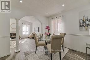 Brampton (Fletcher's West) apartment for rent - A well-lit, spacious living room with a dining area in the background.