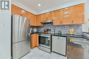 Brampton (Fletcher's West) apartment for rent - A kitchen with wooden cabinets and a stainless steel refrigerator.