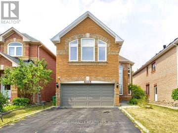 Mississauga (Hurontario) apartment for rent - A brick house with a garage door numbered 5423 is for sale.