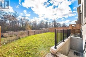 Brampton (Northwest Brampton) apartment for rent - A backyard with a fence and a small concrete structure.