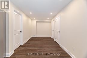 Brampton (Northwest Brampton) apartment for rent - A long hallway with wood floors and white walls.