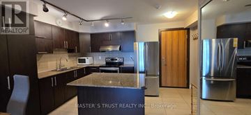 Markham (Unionville) condo for rent - A kitchen with a granite countertop and stainless steel appliances.