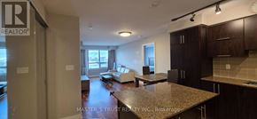 Markham (Unionville) condo for rent - A kitchen area with a granite countertop and cabinets.