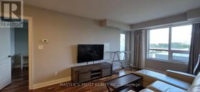Markham (Unionville) condo for rent - A living room with a flat screen TV and a large window.