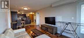 Markham (Unionville) condo for rent - A living room with a couch, a television, and a coffee table.