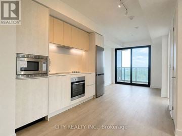 Mississauga (Cooksville) condo for rent - A modern kitchen with wooden cabinets and stainless steel appliances.