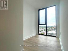 Mississauga (Cooksville) condo for rent - A room with a view of the city through large windows.