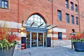 Toronto (Bay Street Corridor) condo for rent - The front of a building with a large glass door and a sign that says Canada Home Group Realty Inc. Brokerage.