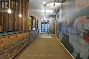 Toronto (Bay Street Corridor) condo for rent - A hallway with a wooden wall on the left and a mural on the right.