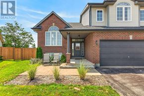 West Lincoln (Smithville) apartment for rent - A house with a red brick facade and a grey garage door.