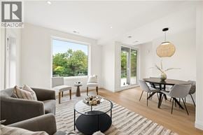 Kitchener apartment for rent - A modern living room with a glass table and a sofa.