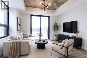 Brantford condo for rent - A living room with a couch, chair, and television.