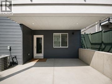 Coquitlam apartment for rent - A modern house with a grey exterior and a white roof.
