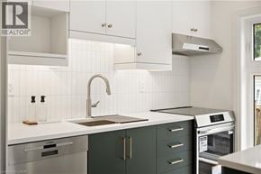 Kitchener apartment for rent - A modern kitchen with white and green cabinets.