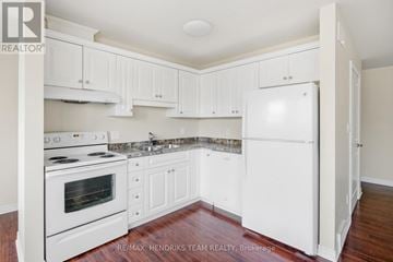 St. Catharines (Carlton/Bunting) apartment for rent - A kitchen with white cabinets and appliances.