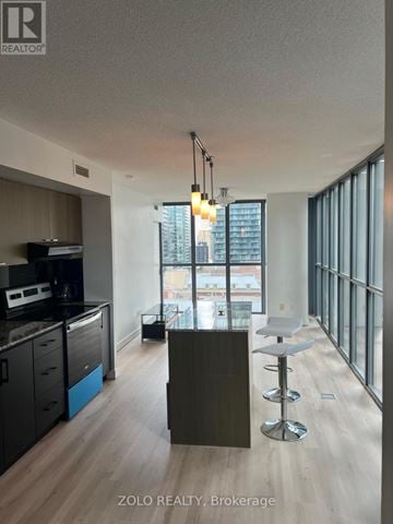 Toronto (Church-Yonge Corridor) condo for rent - A modern kitchen with a bar stool and a counter.