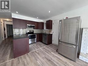 Vancouver apartment for rent - A kitchen with a refrigerator, oven, and microwave.
