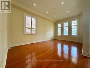 Aurora (Bayview Wellington) apartment for rent - A room with wooden floors and three windows.