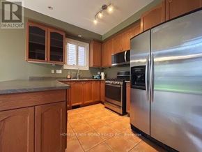 Aurora (Bayview Wellington) apartment for rent - A kitchen with wooden cabinets and a stainless steel refrigerator.