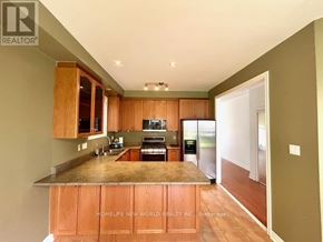 Aurora (Bayview Wellington) apartment for rent - A kitchen with wooden cabinets and a countertop.