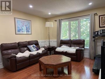 Aurora (Aurora Heights) apartment for rent - A living room with a brown couch and a wooden coffee table.