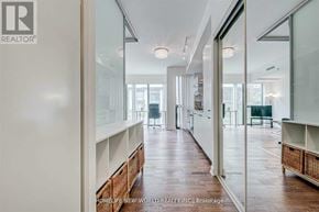 Toronto (Kensington-Chinatown) condo for rent - A long, narrow hallway with white walls and wood floors.