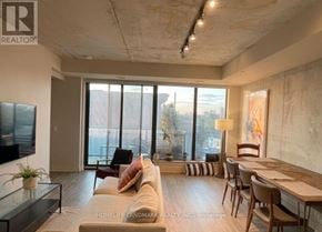 Toronto (Waterfront Communities) condo for rent - A living room with a couch, chairs, and a television.