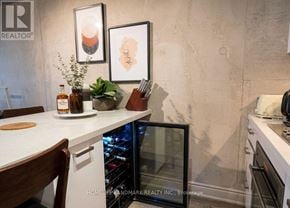 Toronto (Waterfront Communities) condo for rent - A kitchen with a white countertop and a wine cooler in the corner.