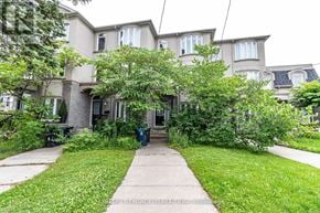 Toronto (Newtonbrook West) townhouse for rent - A building with a green lawn in front.