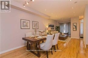 Toronto (Newtonbrook West) townhouse for rent - A dining room with a table set for two and a framed picture on the wall.