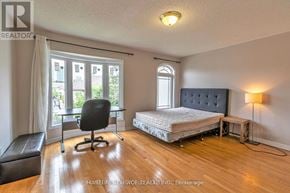 Toronto (Newtonbrook West) townhouse for rent - A bedroom with a bed, chair, and window.