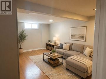 Ottawa townhouse for rent - A living room with a couch, a coffee table, and a potted plant.