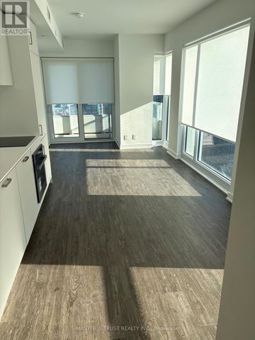 Toronto (Church-Yonge Corridor) condo for rent - A kitchen with a refrigerator, oven, and a window with blinds.