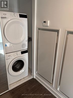 Toronto (Church-Yonge Corridor) condo for rent - A white front loading washing machine in a laundry room.