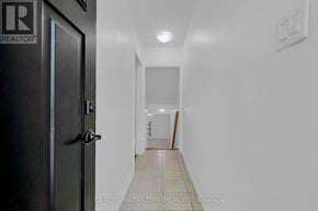 Toronto (Woburn) apartment for rent - A hallway with a door on the left and a light switch on the wall.
