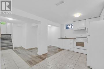 Toronto (Woburn) apartment for rent - A white kitchen with a staircase on the left side.