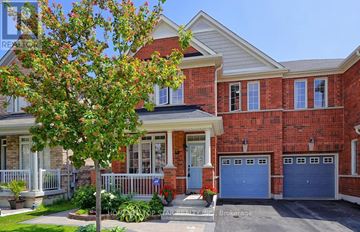 Toronto (Clairlea-Birchmount) apartment for rent - A red brick house with a blue garage door.