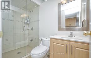 Toronto (Clairlea-Birchmount) apartment for rent - A bathroom with a toilet, sink, and mirror.