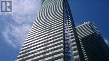 Toronto (Bay Street Corridor) condo for rent - A tall building with the words "Master of Trust Realty Inc., Brokerage" written on it.